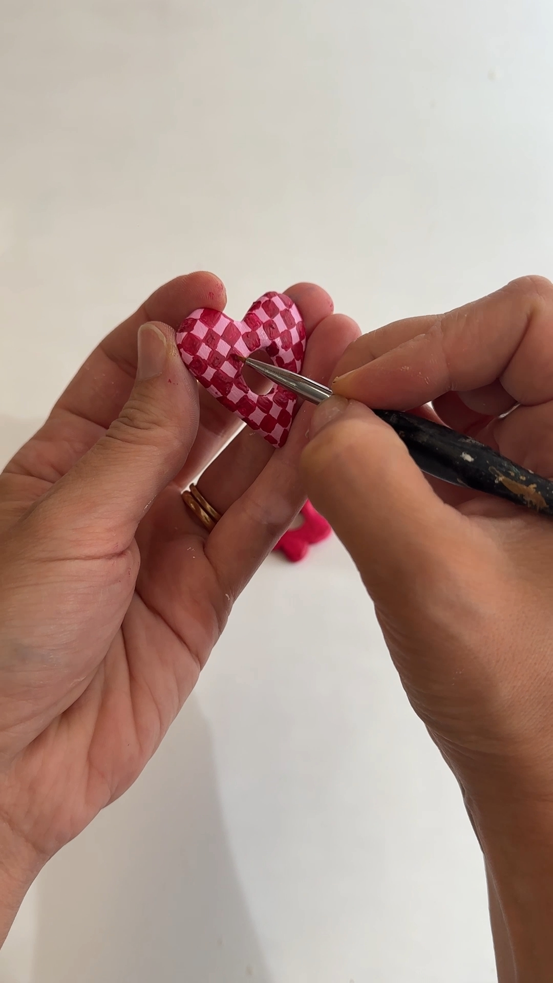 heart clay holders painted with stripes and a checkerboard pattern