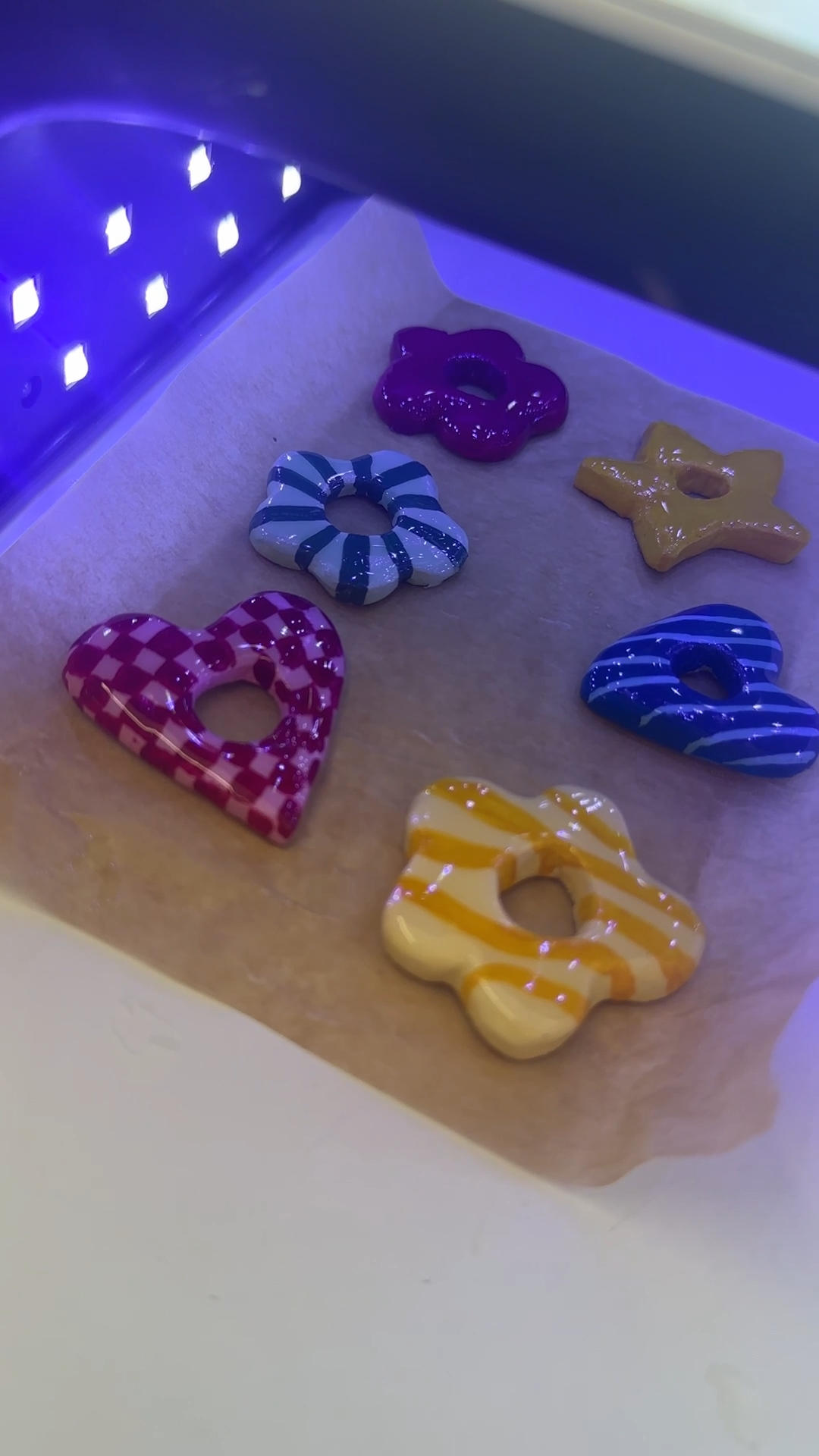 glossy uv resin being applied to a painted air dry clay sunglasses holder