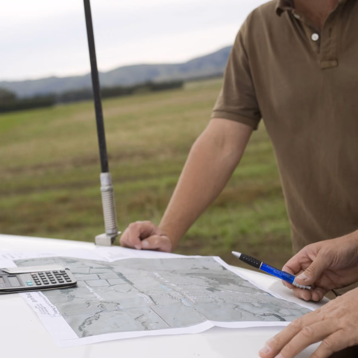Person reviewing a site plan outdoors