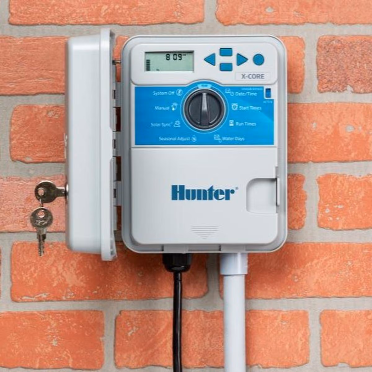 Hunter irrigation controller mounted on a brick wall