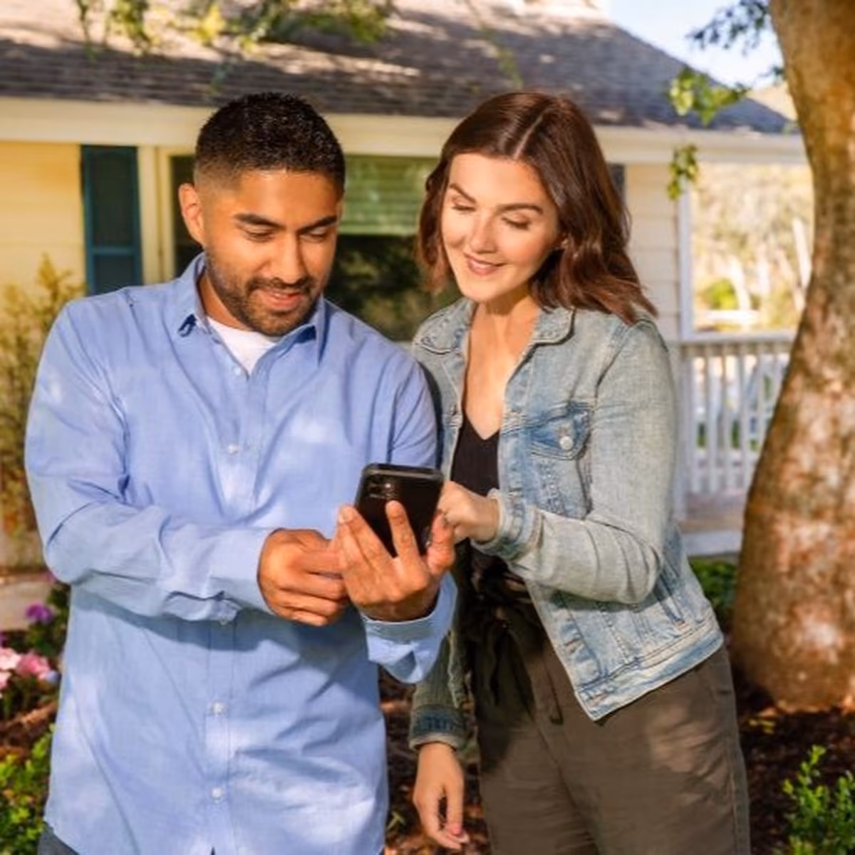 Couple checking an irrigation app on a phone