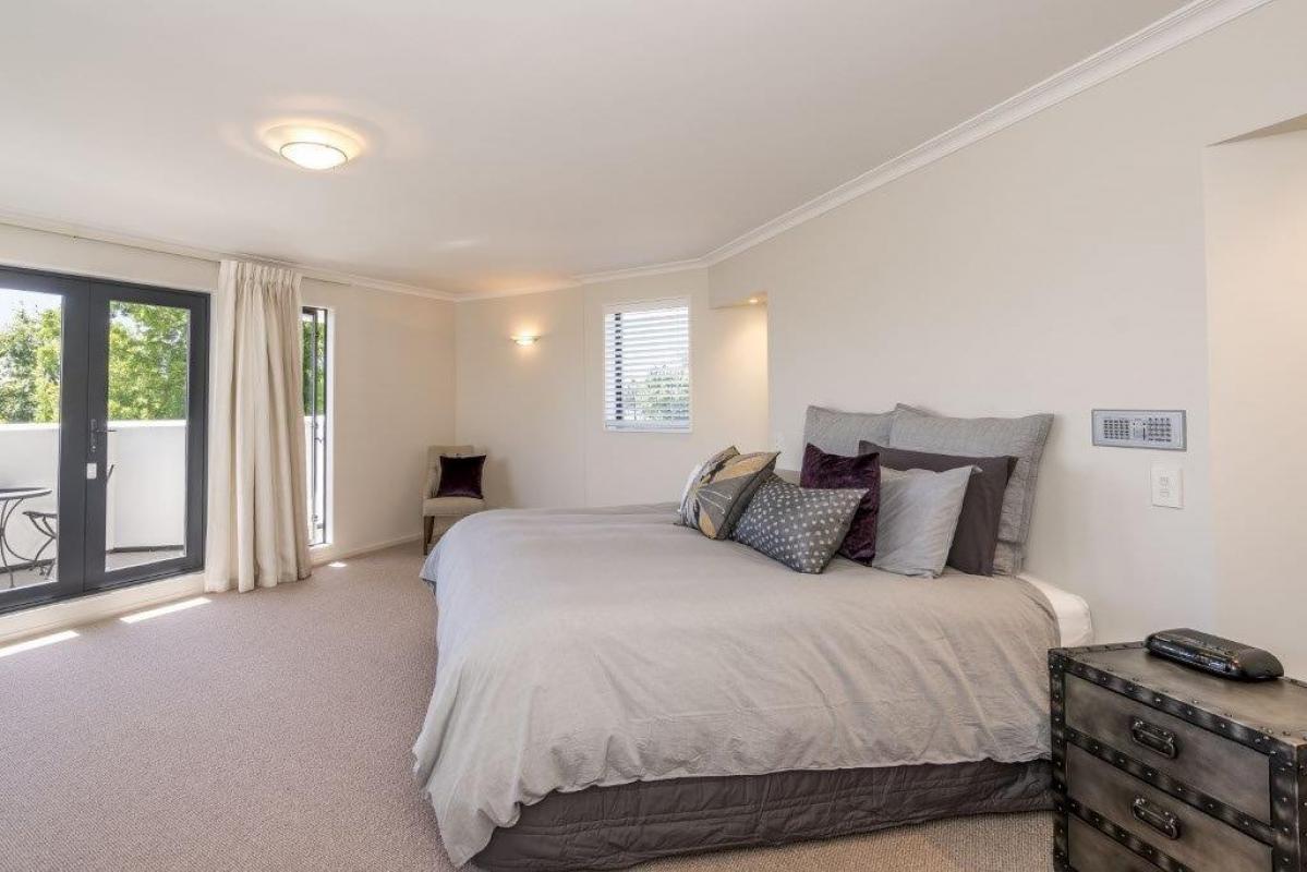 Bedroom with neutral tones, new double glazed windows, updated fittings and soft lighting