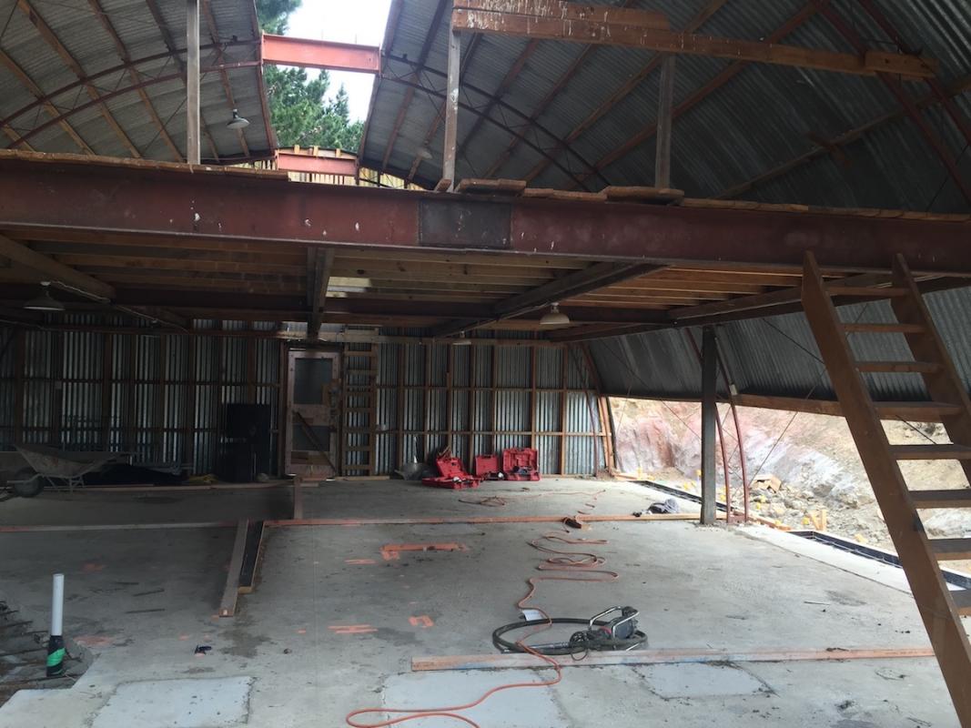 Construction progress view of the barn conversion interior showing the stripped structure and curved roofline during earthquake strengthening