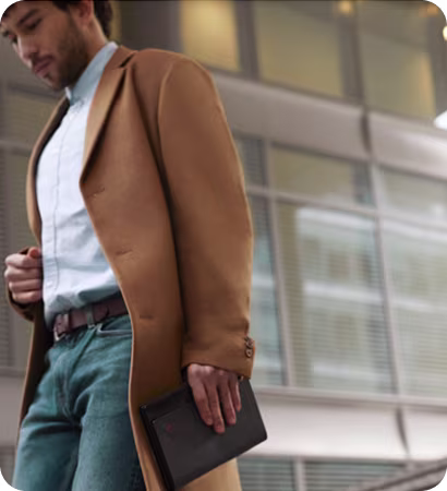 Professional carrying Lenovo ThinkPad X1 Fold in folio case outside office building.