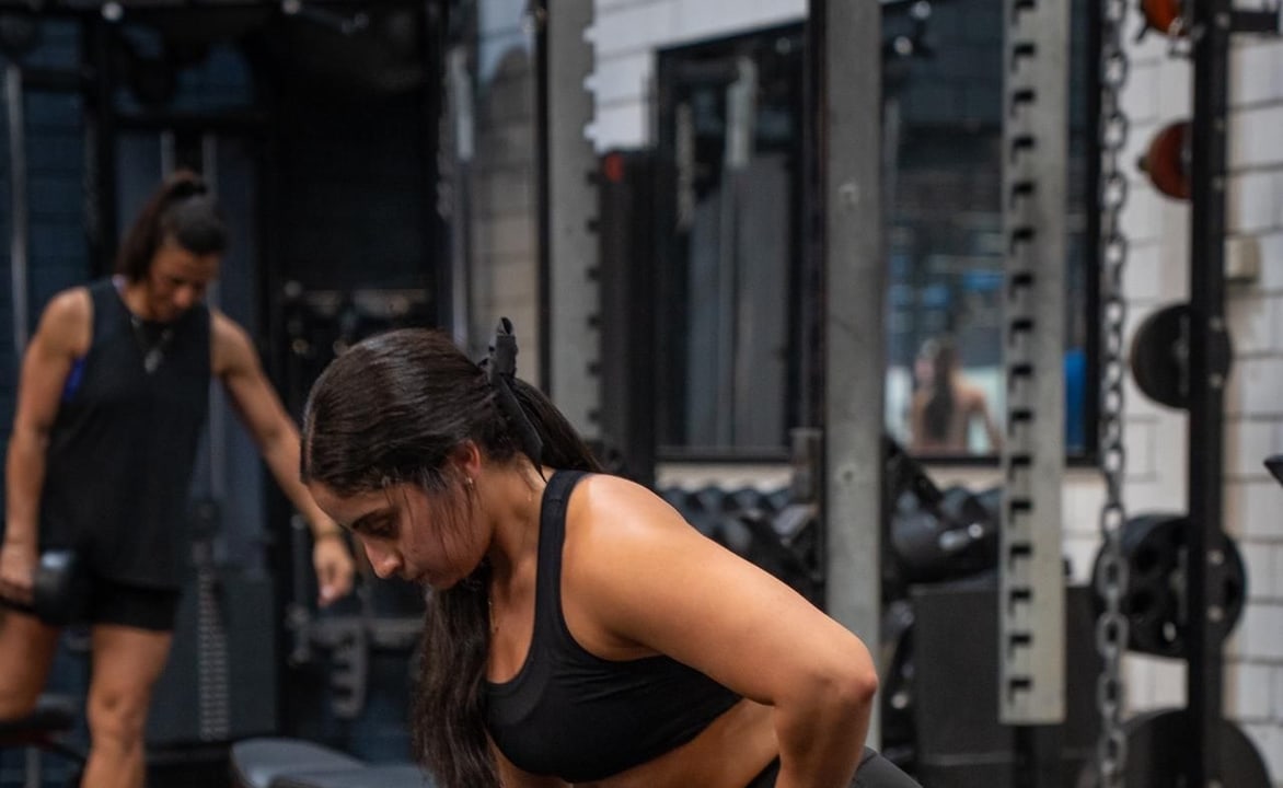 Woman training in the Strength Lab gym at RevX Fitness Society