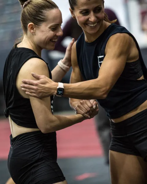 Two women tapping each other in respect