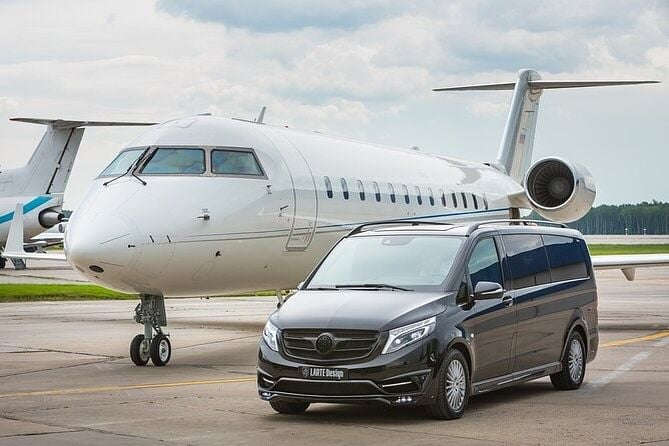 Mercedes V-Class parked beside a private jet on the airport apron