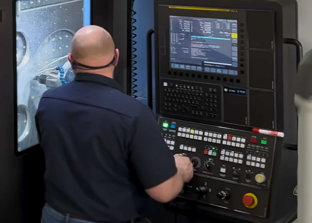 CNC machinist operating advanced manufacturing equipment in the Lindquist Machine facility