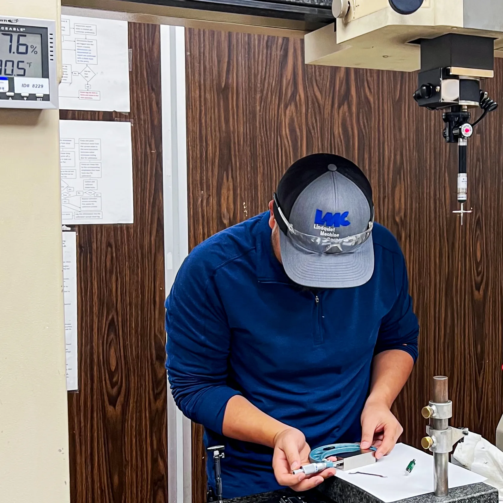 Technician performing dimensional inspection as part of a documented quality program