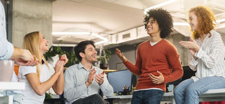 Employees celebrating together in a meeting 