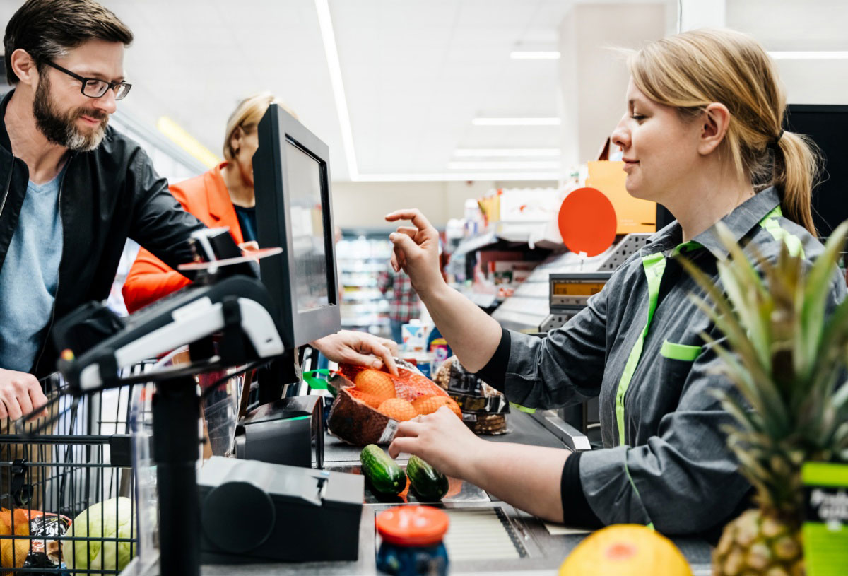 Retail employee working a cash register