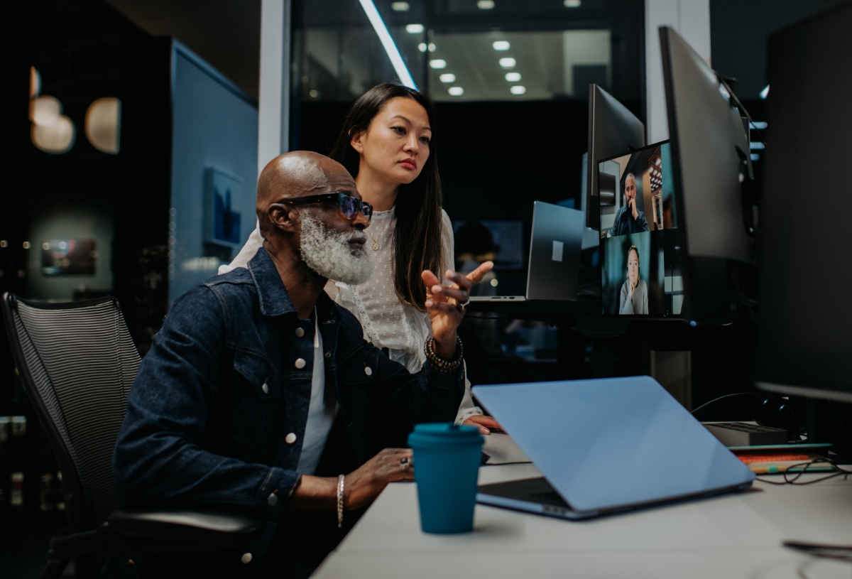 Tech employees reviewing information on a computer