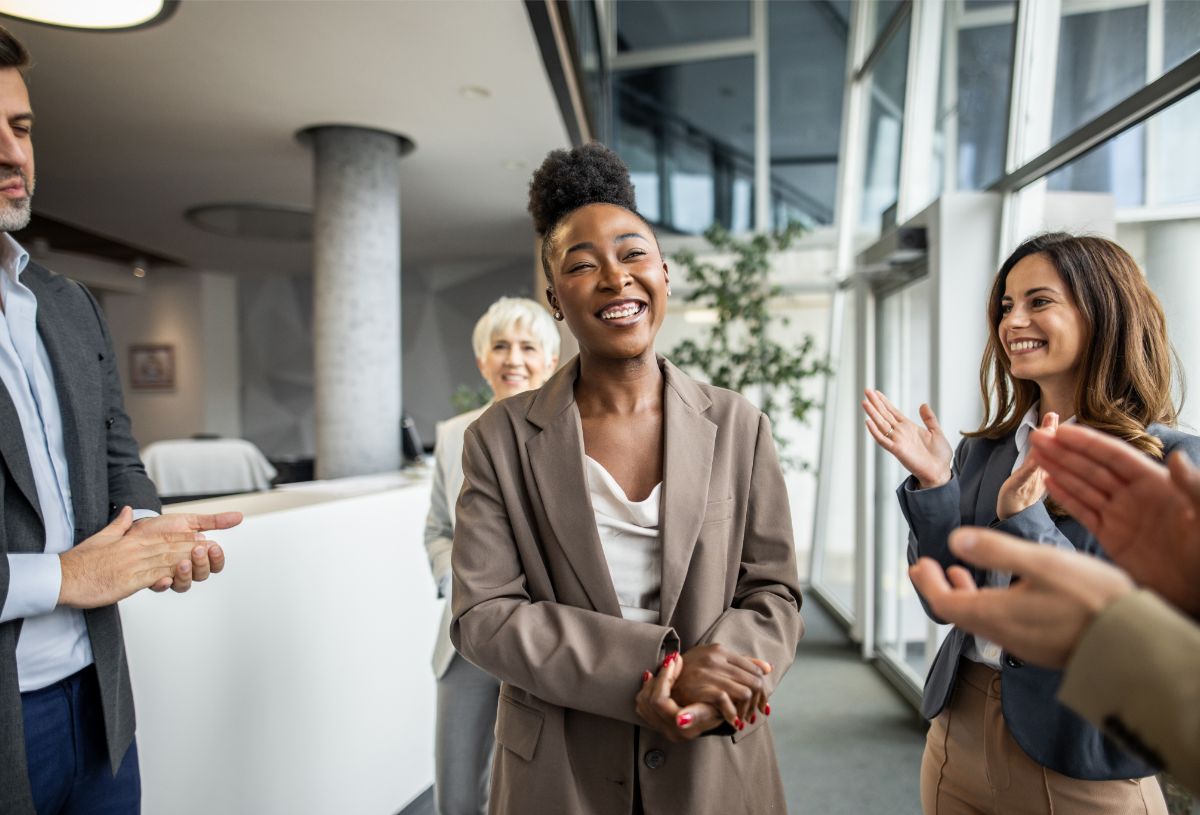 A team applauding a coworker