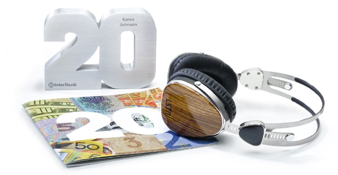 Awards for a career anniversary including a Yearbook by O.C. Tanner filled with personal notes from teammates, a custom career numeral, and headphones.