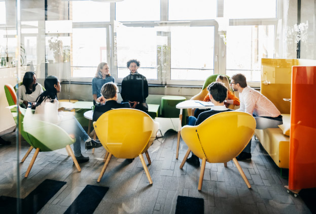 A team of employees gathered together for a meeting in an office.