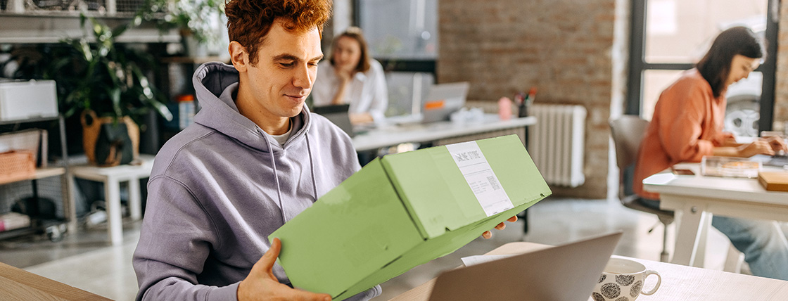 Remote employee opening a company swag box