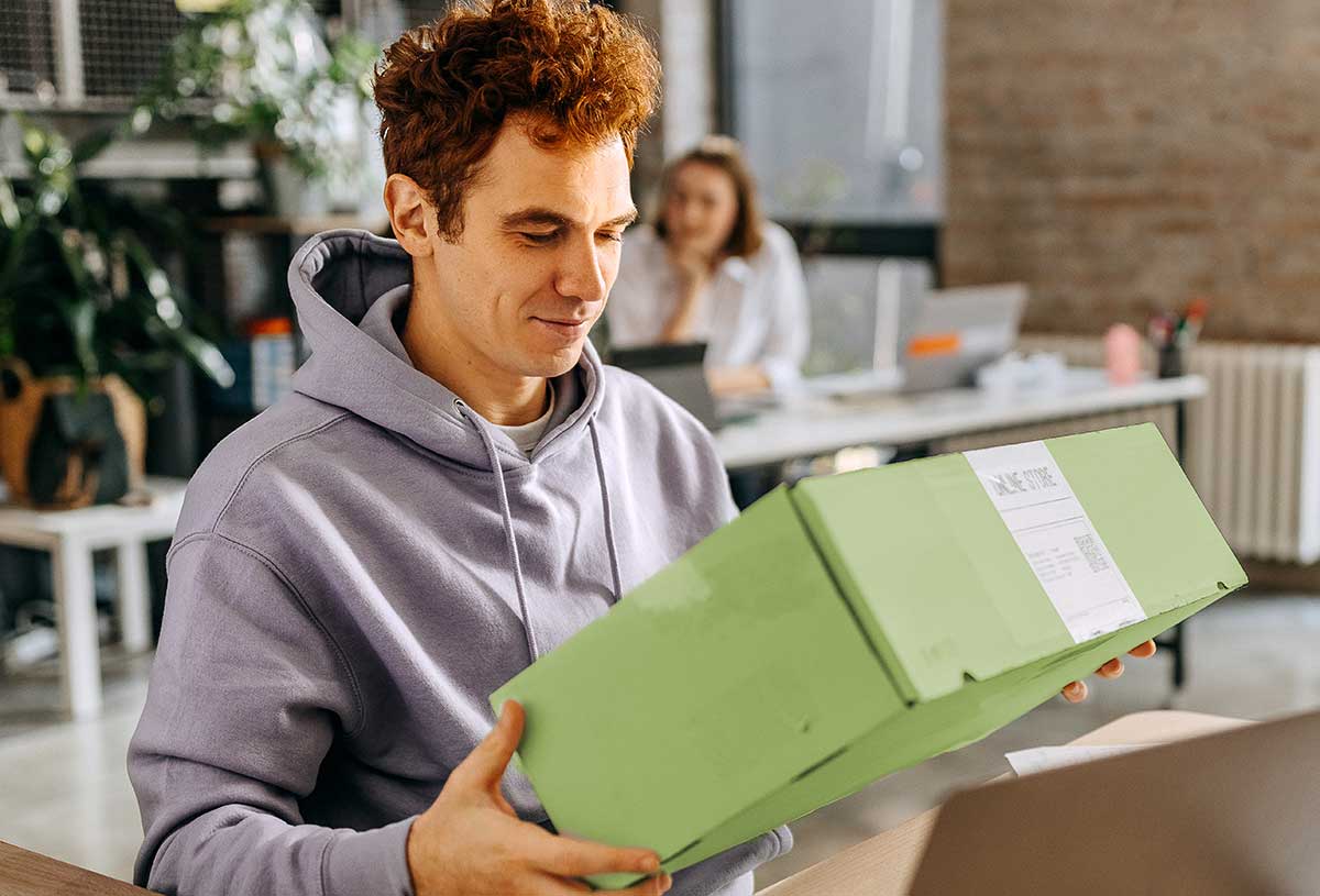 Remote employee opening a company swag box