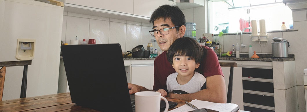 Remote employee working in the kitchen with their child
