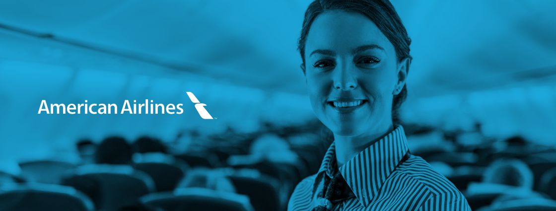 The American Airlines logo overlaid on a photo of a flight attendant on a plane