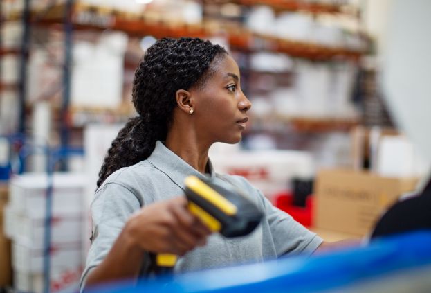 Deskless warehouse employee scanning shipments