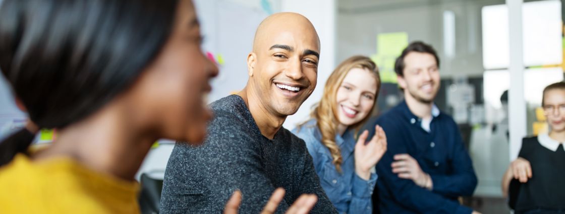 Employees holding a ”get to know you” session with each other in an office space