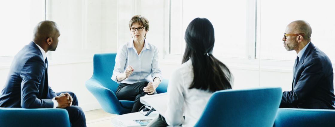 Employees holding a meeting in an office