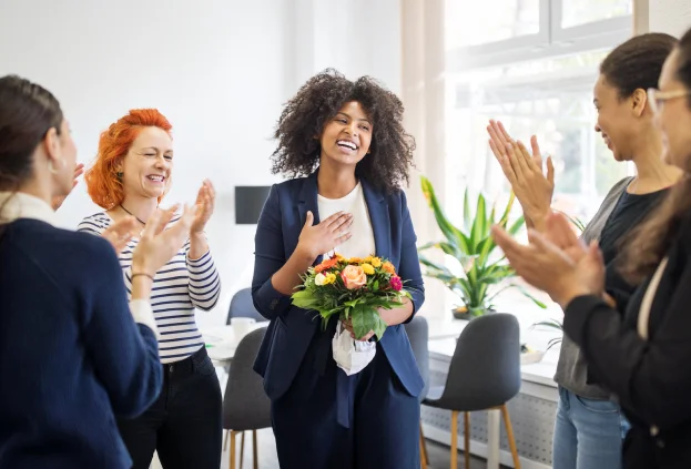 Image of a team celebrating together in an office