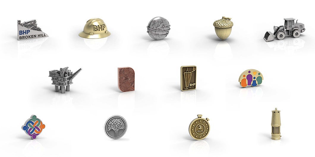 An image showcasing BHP's custom-designed symbolic pins for work anniversaries, including a hard hat, a compass, a map, and other meaningful symbols to BHP's employees