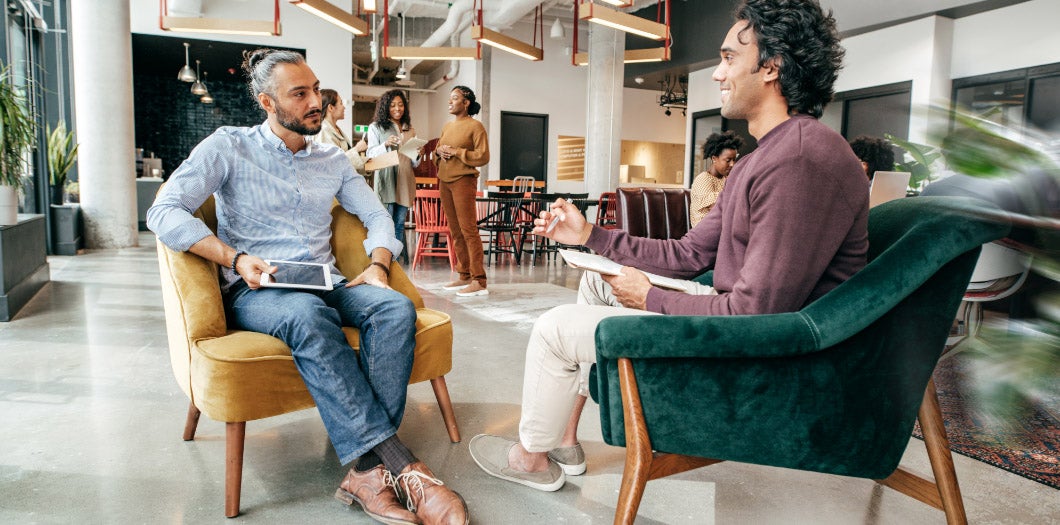 Teammates meeting one on one in an office