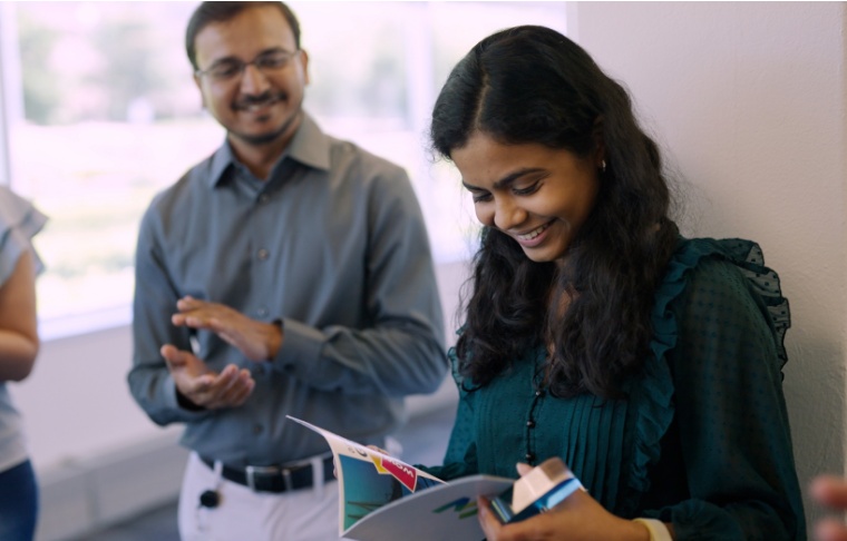 O.C. Tanner employee receiving their Yearbook for a career anniversary