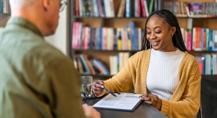 Two employees reviewing a contract