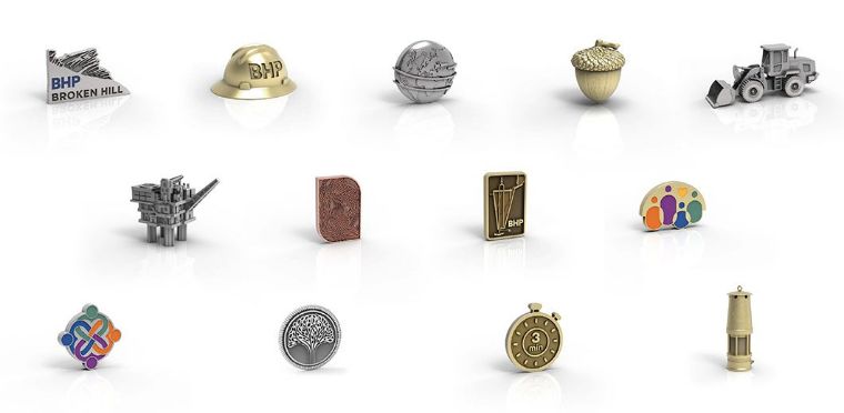 BHP’s custom pins for celebrating career milestones, including a hard hat, mining equipment, and maps, designed and manufactured by O.C. Tanner