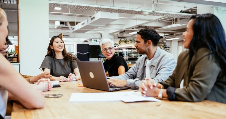 Employees laughing during a meeting