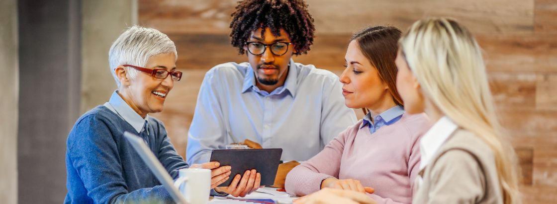 Employees from different generations gathered for a meeting in an office