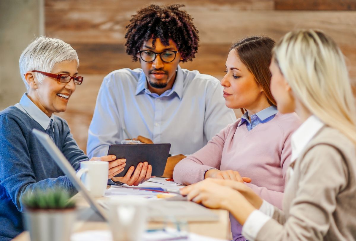 Employees from different generations gathered for a meeting in an office
