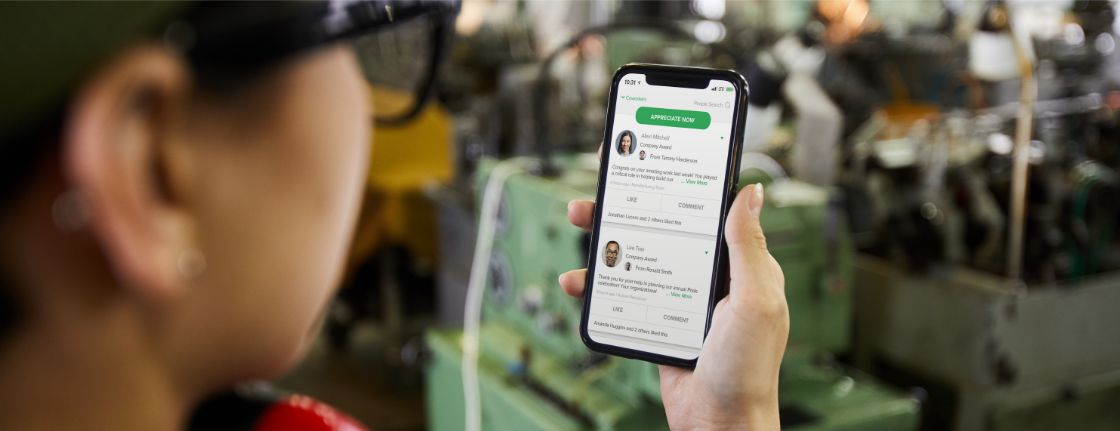 A manufacturing employee using the Culture Cloud platform on a mobile phone