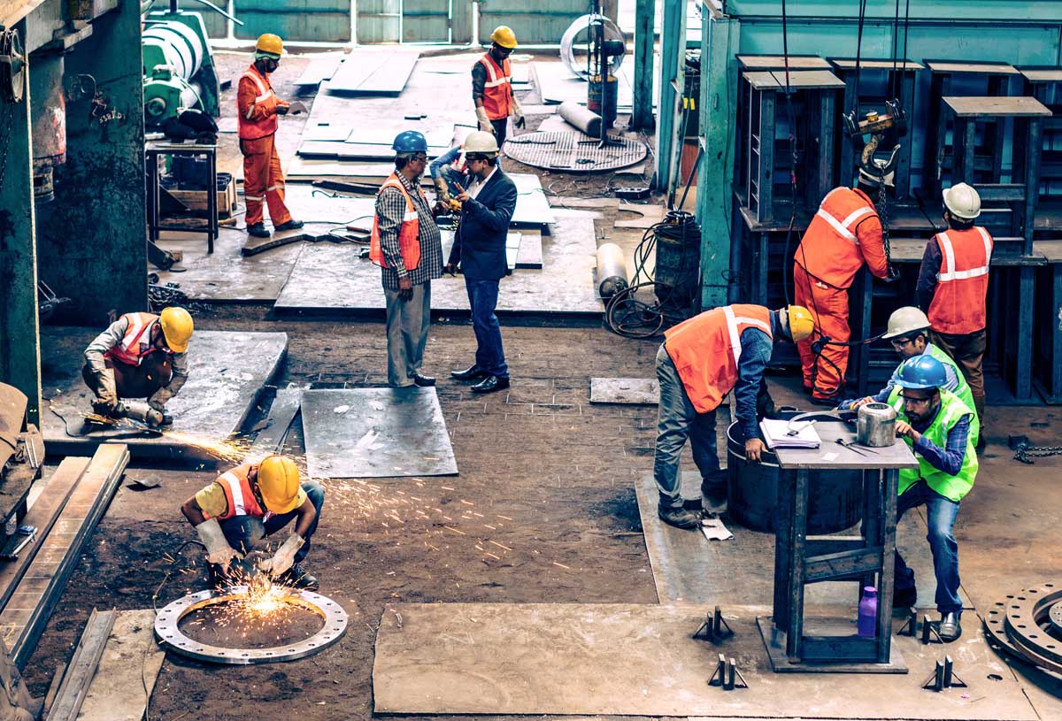 Employees working at a metal manufacturing facility