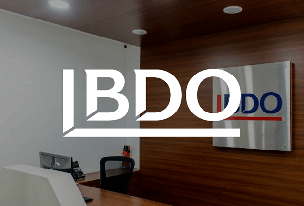 A desk with a placard behind it at a BDO office