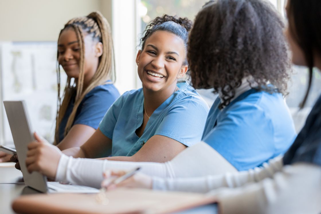 Nurses talking with one another in a medical training class