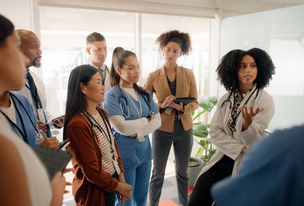 A medical team attends a meeting in an office