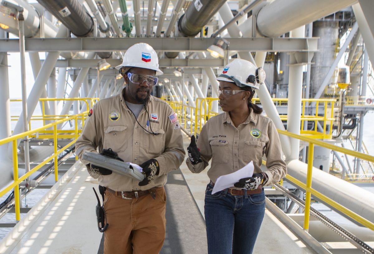 Two Chevron employees having a discussion on a job site