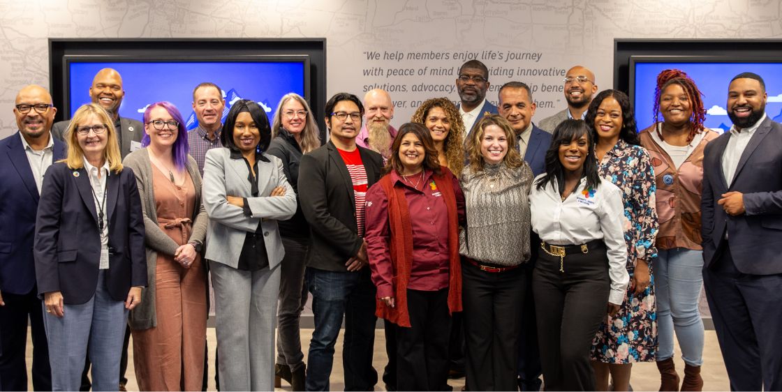 A group portrait of AAA employees at a training and reception event