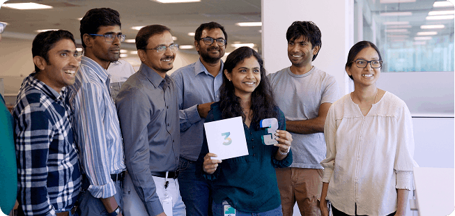 A group of employees giving a gift.