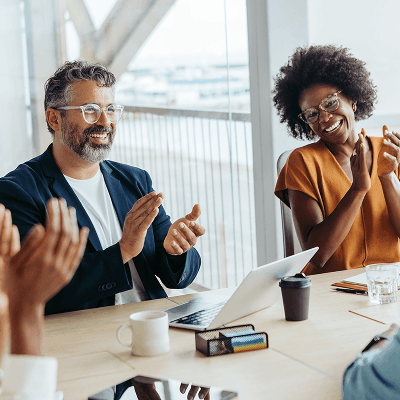 Employees clapping in a meeting room