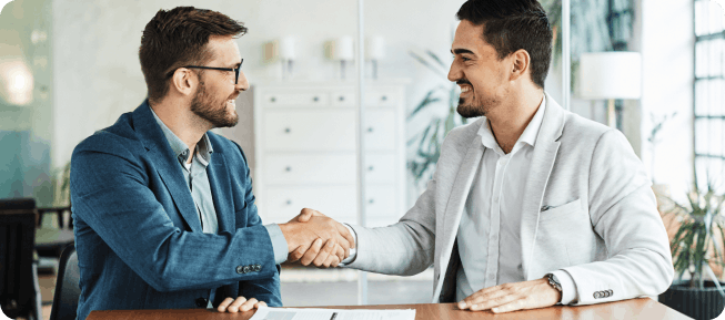 A new employee shaking hands with another employee