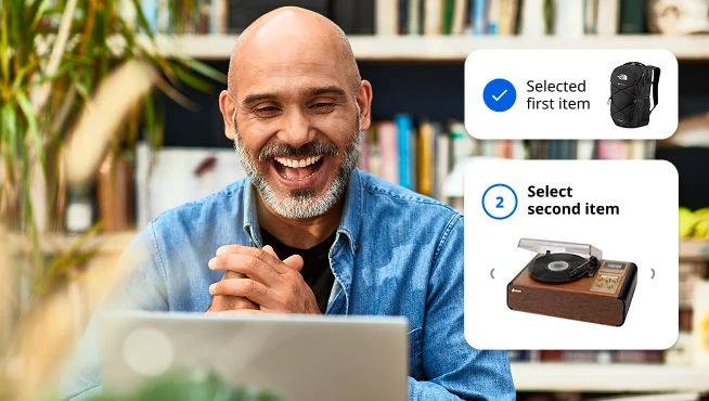 An employee on a laptop using O.C. Tanner's gift pairing experience to choose two gifts for a recognition moment.