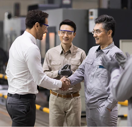 Manufacturing employees shaking hands