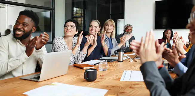 Employees celebrating in a meeting room