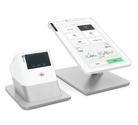 Modern white and gray point-of-sale system with a touchscreen display showing a payment interface and a card reader with contactless payment symbol.