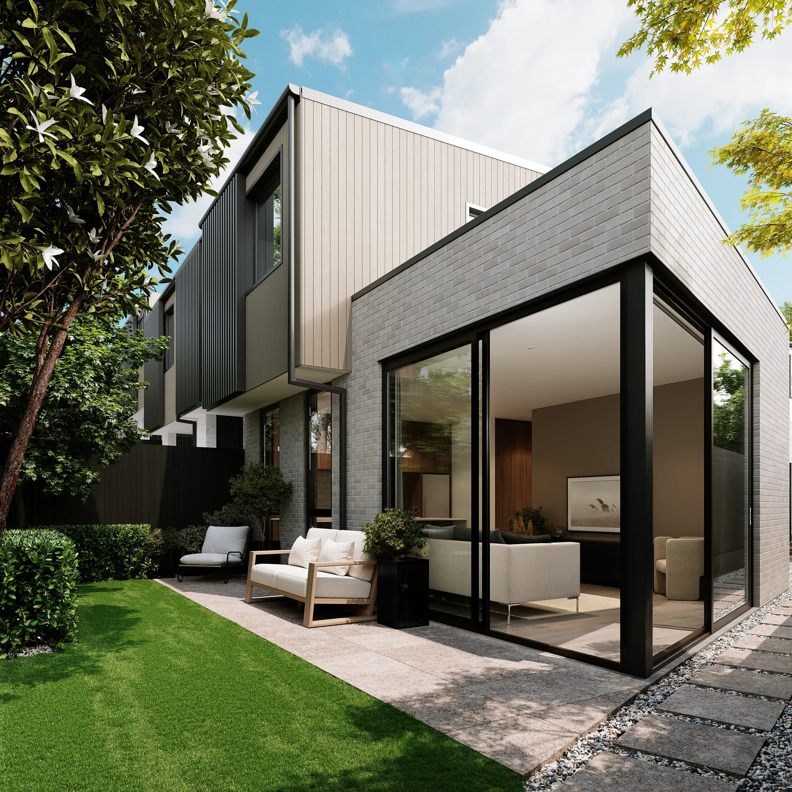 Modern house with large glass windows opening to a patio with outdoor seating and green lawn.